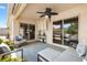 Relaxing covered lanai with stylish seating, ceiling fan, and sliding doors, perfect for outdoor enjoyment and entertaining at 2325 Kenya St, The Villages, FL 32162