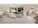 Bright living room featuring a modern entertainment center, neutral decor, and sliding glass doors to the lanai at 2325 Kenya St, The Villages, FL 32162
