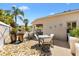 Covered patio area featuring decorative pots, comfortable seating, pavers and custom landscape at 2325 Kenya St, The Villages, FL 32162