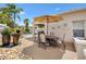 Outdoor patio area featuring a dining table with umbrella, decorative pots and custom landscape at 2325 Kenya St, The Villages, FL 32162