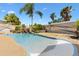 Beautiful pool area with rock waterfall feature and lush landscaping and custom painted privacy fence at 2325 Kenya St, The Villages, FL 32162