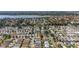 Wide aerial shot of a large community with diverse home styles, mature trees, and serene lakes, offering a peaceful environment at 2348 Riley Rd, The Villages, FL 32162