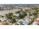 Stunning aerial view of community amenities, including a sparkling pool, clubhouse, and serene lakes surrounded by lush greenery at 2348 Riley Rd, The Villages, FL 32162