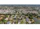 An aerial view showing a large residential area near a pond, emphasizing the layout and green spaces at 2348 Riley Rd, The Villages, FL 32162
