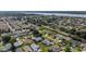 Expansive aerial view of single-Gathering homes within a well-planned community featuring mature trees, green spaces, and quiet streets at 2348 Riley Rd, The Villages, FL 32162
