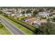 An aerial view of a quiet, well-maintained residential neighborhood with manicured lawns and mature trees at 2348 Riley Rd, The Villages, FL 32162