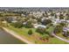 Picturesque aerial view of a community showcasing a pool, clubhouse, and lake, all surrounded by lush greenery and mature trees at 2348 Riley Rd, The Villages, FL 32162