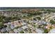 Expansive aerial view of a well-established community featuring diverse home styles, mature trees, and serene lakes at 2348 Riley Rd, The Villages, FL 32162