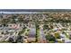 Wide aerial view of a diverse community featuring single-Gathering homes, mature trees, and serene lakes, creating a peaceful environment at 2348 Riley Rd, The Villages, FL 32162