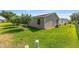 View of the home's backyard with vinyl siding and simple, manicured landscaping at 2348 Riley Rd, The Villages, FL 32162
