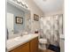 Bathroom featuring a vanity, mirror, and shower with stylish leaf-patterned curtain at 2348 Riley Rd, The Villages, FL 32162