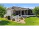 A well-maintained property with a screened porch and a lush, green lawn at 2348 Riley Rd, The Villages, FL 32162