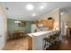 Kitchen features breakfast bar, white appliances, and tile flooring at 2348 Riley Rd, The Villages, FL 32162