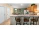 Cozy kitchen bar with wooden cabinets and seating for relaxed dining at 2348 Riley Rd, The Villages, FL 32162