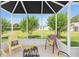 A screened lanai with seating provides a relaxing outdoor space with a view of the lush backyard at 2348 Riley Rd, The Villages, FL 32162