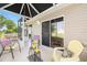 A screened lanai with seating provides a relaxing outdoor space with a view of the landscaped backyard at 2348 Riley Rd, The Villages, FL 32162