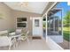 Enclosed lanai with table and chairs, ceiling fan, and view of the backyard at 2348 Riley Rd, The Villages, FL 32162