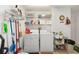 Well-equipped laundry room with washer, dryer, and ample storage space at 2348 Riley Rd, The Villages, FL 32162
