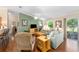 Spacious living room featuring wood floors, neutral paint, and seamless flow into the backyard at 2348 Riley Rd, The Villages, FL 32162