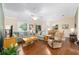 Spacious living room with hardwood floors and natural lighting adjacent to dining area at 2348 Riley Rd, The Villages, FL 32162