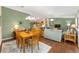 Bright living room featuring hardwood floors, open layout, and dining table at 2348 Riley Rd, The Villages, FL 32162