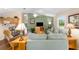 A cozy living room offers a relaxing area, with a serene color scheme and natural light at 2348 Riley Rd, The Villages, FL 32162