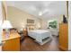 Inviting main bedroom features a ceiling fan and a large window with natural light at 2348 Riley Rd, The Villages, FL 32162
