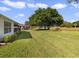 Expansive backyard with lush green lawn and mature trees at 239 Juniper Way, Tavares, FL 32778