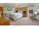Comfortable bedroom with a large window offering backyard views and a relaxing rocking chair at 239 Juniper Way, Tavares, FL 32778