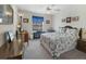Cozy bedroom with a patterned comforter, desk, ceiling fan, and natural light at 239 Juniper Way, Tavares, FL 32778