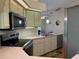 Bright kitchen with stainless steel appliances, light-colored cabinetry, and ample countertop space at 239 Juniper Way, Tavares, FL 32778