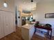 Open concept kitchen features a center island, modern lighting, and ample cabinet space at 239 Juniper Way, Tavares, FL 32778