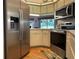 Well-equipped kitchen with modern appliances, and wood-look flooring, ready for culinary adventures at 239 Juniper Way, Tavares, FL 32778