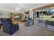 Cozy living room with a plush seating arrangement, ceiling fan, and sliding doors to the outdoor patio at 239 Juniper Way, Tavares, FL 32778