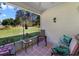 Relaxing covered patio with comfortable seating and a view of the landscaped yard at 239 Juniper Way, Tavares, FL 32778
