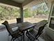 View of back patio with outdoor dining set, overlooking fenced backyard at 254 Locust Pass Dr, Ocala, FL 34472