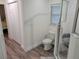 Bathroom featuring tile floors, a toilet, shower and linen closet at 254 Locust Pass Dr, Ocala, FL 34472