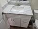 Close up of the bathroom vanity with marble countertop and white cabinets at 254 Locust Pass Dr, Ocala, FL 34472