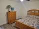 Cozy bedroom with wood furnishings, wood-look floors, and a quaint floral bedspread at 254 Locust Pass Dr, Ocala, FL 34472