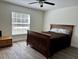 Bedroom featuring a full-sized bed, ceiling fan, and natural light from the window at 254 Locust Pass Dr, Ocala, FL 34472