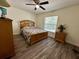 Bright bedroom featuring a full-sized bed, dresser, and natural light at 254 Locust Pass Dr, Ocala, FL 34472