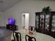 Elegant dining area with a table set for dinner and a decorative china cabinet against the wall at 254 Locust Pass Dr, Ocala, FL 34472