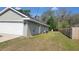 Exterior view of the home with a garage, back door, and wooden fence at 254 Locust Pass Dr, Ocala, FL 34472