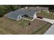 Aerial view of a beautiful single Gathering home featuring a neutral color palette, a private driveway, and green landscaping at 254 Locust Pass Dr, Ocala, FL 34472