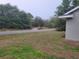 Residential street view with lush lawn and mature trees at 254 Locust Pass Dr, Ocala, FL 34472