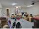 Spacious garage interior filled with boxes, storage, and a water heater at 254 Locust Pass Dr, Ocala, FL 34472