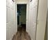 Hallway with white doors and wood-look flooring at 254 Locust Pass Dr, Ocala, FL 34472