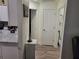 Hallway leading to bedrooms and featuring white doors and wood-look flooring at 254 Locust Pass Dr, Ocala, FL 34472