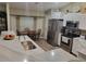 Well-lit kitchen featuring stainless steel appliances, light countertops, and an adjacent breakfast nook at 254 Locust Pass Dr, Ocala, FL 34472