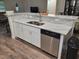 Kitchen island with stainless steel appliances, double sink and bar seating provides a welcoming space at 254 Locust Pass Dr, Ocala, FL 34472